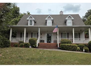 Charming single Gathering home featuring a wide front porch and well manicured front yard and inviting curb appeal at 3592 Galdway Dr, Snellville, GA 30039
