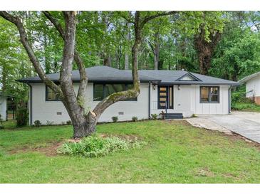 Charming renovated ranch home with a painted brick facade, dark trim and new front door at 140 Larose Se Cir, Marietta, GA 30060