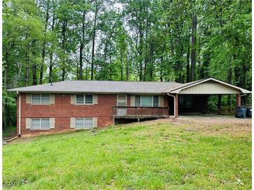 Charming brick home featuring a welcoming front porch and a convenient covered carport at 3287 Harvest Way, Marietta, GA 30062