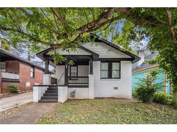 Charming bungalow with a brick foundation, covered porch, and well-manicured lawn at 554 Lawton Sw St, Atlanta, GA 30310