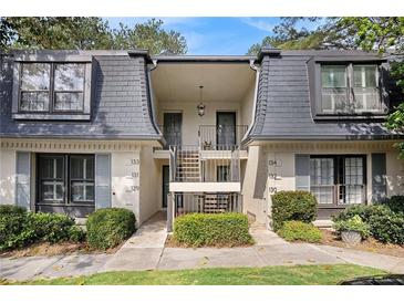 Charming condo exterior showcasing well-maintained landscaping and a welcoming entrance at 133 Maison Nw Pl, Atlanta, GA 30327