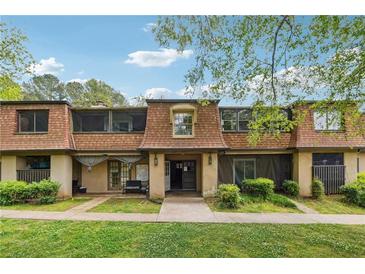 Charming townhome with a well-manicured lawn and inviting curb appeal, perfect for comfortable living at 2930 Parc Lorraine, Lithonia, GA 30038