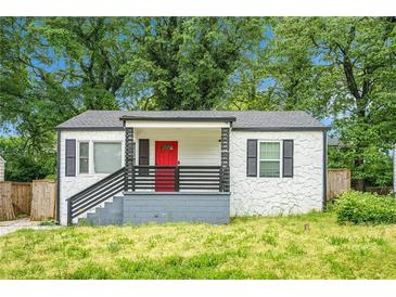 Charming bungalow with stone exterior, red front door, and a well-maintained front yard at 248 Upshaw Sw St, Atlanta, GA 30315