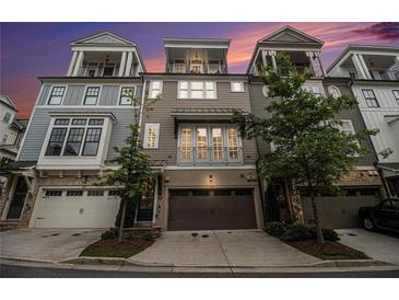 Attractive townhome exterior with an attached garage and small trees at 289 Heritage Se Ln, Atlanta, GA 30316
