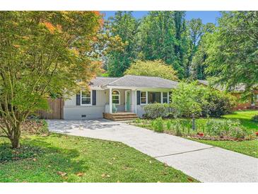 Charming home with a well-manicured lawn and a paved driveway at 2205 Desmond Dr, Decatur, GA 30033