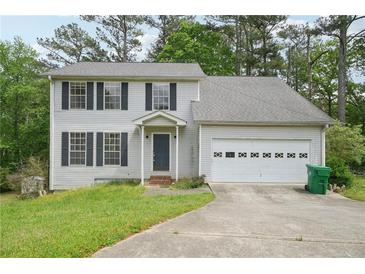 Charming two-story home featuring a classic colonial design and an attached two-car garage at 7117 Stonebrook Cv, Lithonia, GA 30058