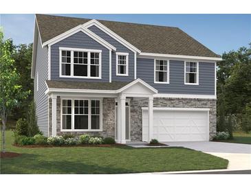Charming two-story home showcasing stone accents, light blue siding, and a well-manicured lawn at 7252 Eton Ln, Locust Grove, GA 30248