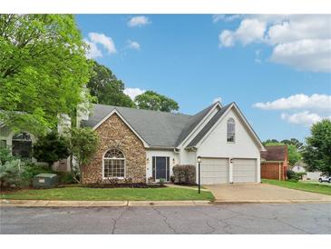 Charming home with stone accents, two-car garage and well-manicured lawn at 979 Bridgegate Ne Dr, Marietta, GA 30068
