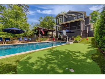 Stunning backyard with a pool, putting green, and outdoor seating area perfect for entertaining at 2406 Glenwood Ne Dr, Atlanta, GA 30305