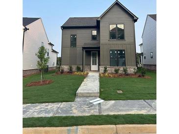 Two-story home featuring a well-kept lawn, neutral siding, and an inviting front entrance at 3472 Adler Trl, Buford, GA 30519