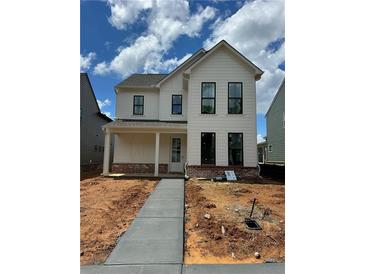 Charming two-story home with white siding, black framed windows, and a welcoming front porch at 3482 Adler Trl, Buford, GA 30519