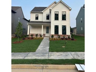Charming two-story home with a beautifully landscaped front yard and classic white siding at 3482 Adler Trl, Buford, GA 30519