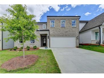 Charming two-story brick home with an attached two-car garage and newly planted front yard at 3968 Annsbury Court, Lilburn, GA 30047