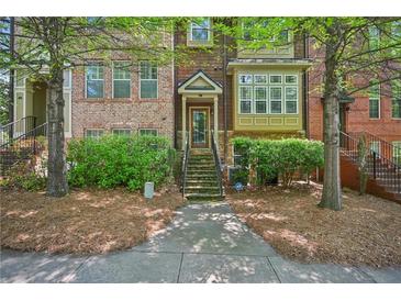 Charming townhome featuring a brick facade, lush landscaping, and a welcoming entrance at 62 High Top Pt, Sandy Springs, GA 30328