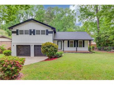 Charming two-story home with a well-maintained lawn and a two-car garage at 1728 Hudson Rd, Decatur, GA 30033