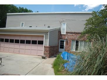 Two story home featuring a garage with a pink door, brick and vinyl siding at 3215 Hembry Ct, Marietta, GA 30062