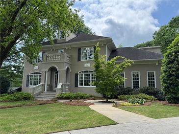 Elegant two-story home with a charming balcony and well-manicured lawn at 2038 Lee Se Rd, Smyrna, GA 30080