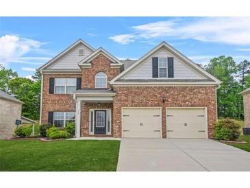 Charming two-story brick home with a well-manicured lawn and a two-car garage at 113 Expedition Dr, Ellenwood, GA 30294