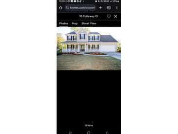 Charming two-story home features a welcoming front porch, manicured lawn, and attached garage, creating curb appeal at 10 Callaway Ct, Hiram, GA 30141