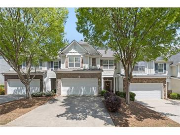 Charming townhome with a well-manicured front yard and attached two-car garage at 441 Mountain View Ln, Woodstock, GA 30188