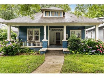 Charming home with a welcoming front porch and beautiful landscaping at 120 Warren Ne St, Atlanta, GA 30317