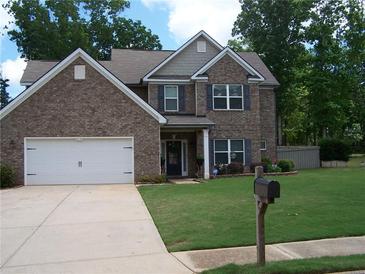 Charming brick two-story home featuring a well-maintained lawn and a two-car garage at 70 Paladin Dr, Covington, GA 30016