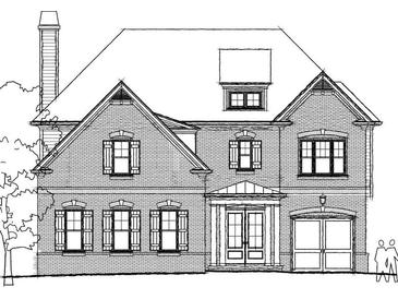 Charming brick home featuring a well-manicured front yard and attached two-car garage at 11350 Bennett Ln, Johns Creek, GA 30097