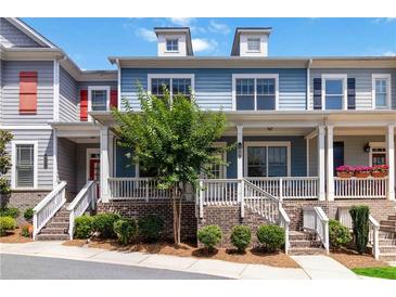 Charming townhome featuring a brick foundation, inviting porch, and well-maintained landscaping at 510 Suwanee Pass Ln, Suwanee, GA 30024