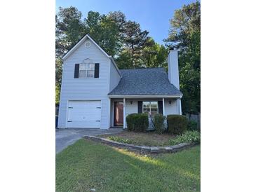 Charming two-story home with a well-maintained lawn and a traditional garage at 1034 Hillsborough Nw, Kennesaw, GA 30144