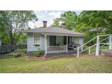Charming cottage-style home with a welcoming front porch and beautifully landscaped front yard at 2881 Parrott Nw Ave, Atlanta, GA 30318