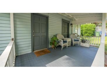 Inviting front porch with comfortable seating, potted plants, and classic design features at 2881 Parrott Nw Ave, Atlanta, GA 30318
