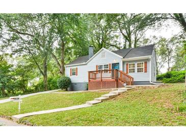 Charming home with a well-manicured lawn, inviting front porch, and quaint architectural details at 1626 Oak Knoll Se Cir, Atlanta, GA 30315