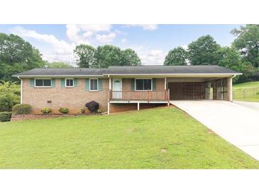 Charming brick home with a well-maintained lawn, covered porch and carport at 4642 Elmhurst Dr, Douglasville, GA 30135
