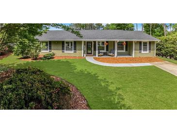 Charming single-story home featuring a well-manicured lawn and inviting front porch at 620 Clearbrook Ct, Marietta, GA 30068