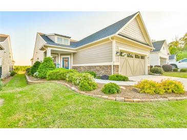 Charming home with a well-manicured lawn and attractive landscaping at 5641 Tisbury Ct, Hoschton, GA 30548