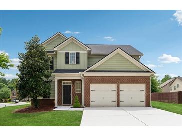 Charming two-story home with a brick facade and manicured front lawn and two-car garage at 2229 Polder Way, Austell, GA 30168