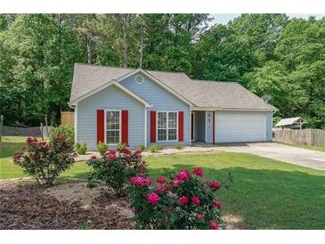 Charming single-Gathering home featuring colorful landscaping, red shutters, and an attached two-car garage at 2889 Estuary Dr, Acworth, GA 30101