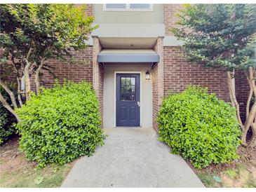 Welcoming front entrance features a solid blue door and manicured landscaping at 3301 Henderson Mill Rd # D3, Atlanta, GA 30341