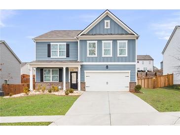Charming two-story home with blue siding, a well-manicured lawn, and a two-car garage at 108 Berwick Crossing, Dallas, GA 30157