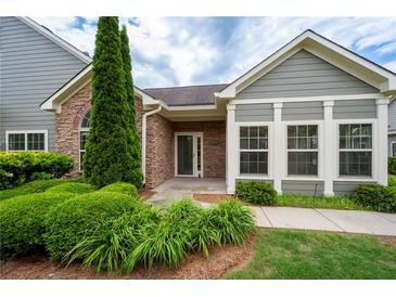 Charming home featuring stone accents, lush landscaping, and a welcoming entrance at 2061 Grove Field Lane #13, Marietta, GA 30064