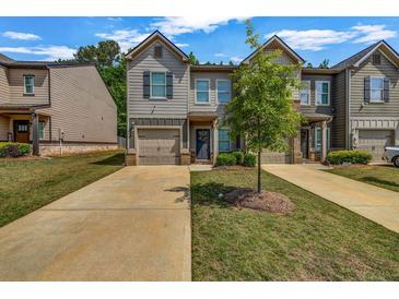 Charming townhome with well-manicured lawn, inviting curb appeal, and convenient garage access at 255 Skipjack Ct, Covington, GA 30016