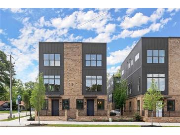 Modern townhouse with a brick facade, dark metal accents, and large windows on a sunny day at 1122 W Marietta St, Atlanta, GA 30318