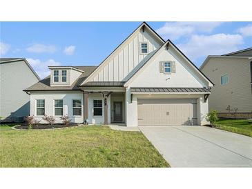Charming single Gathering home featuring a two-car garage and manicured lawn at 35 Henson Farm Dr, Loganville, GA 30052