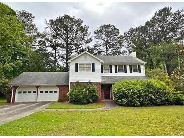 Charming two-story home features a two car garage and mature landscaping in a tranquil, green setting at 3310 Rangers Gate, Marietta, GA 30062