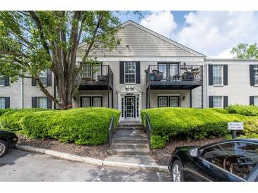 Apartment building exterior featuring balconies, manicured landscaping, and parking at 3440 Essex Ave # 103, Atlanta, GA 30339