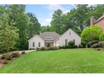 Charming one-story home featuring a well manicured lawn with mature trees offering great curb appeal at 2140 Azalea Dr, Roswell, GA 30075