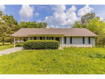 Charming single-story home with a covered carport and a well-maintained lawn and landscaping at 67 Jennifer Ln, Rydal, GA 30171