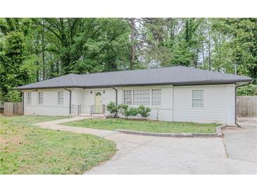 Charming single story home with a neatly maintained yard and walkway leading to a welcoming, bright yellow front door at 2174 Beecher Sw Rd, Atlanta, GA 30311