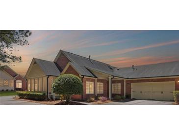 Charming brick home with a well-manicured lawn, a spacious garage, and an inviting entrance at 803 Brookhavenrun Cir, Duluth, GA 30097