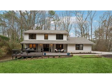 Charming two-story home with a large front yard and inviting deck, perfect for outdoor gatherings at 650 Hunterhill Ct, Roswell, GA 30075